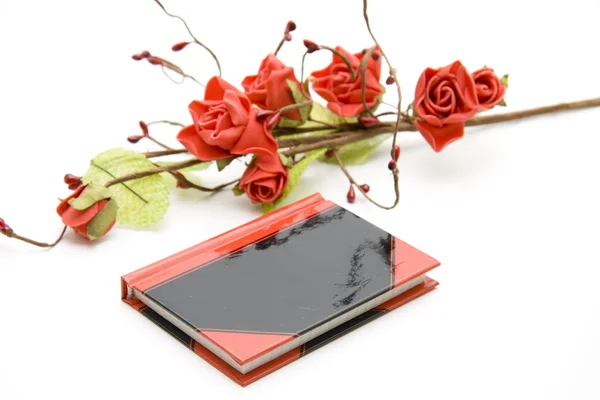 Notebook with rose branch — Stock Photo, Image