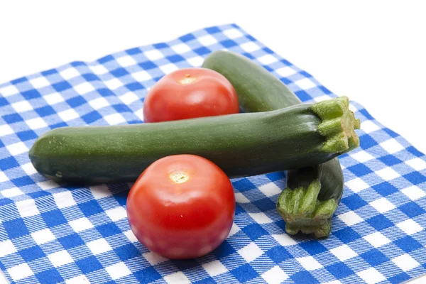 Fresh tomatoes with courgette — Stock Photo, Image