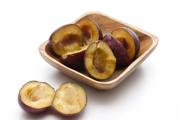 Fresh plums in wooden bowl — Stock Photo, Image