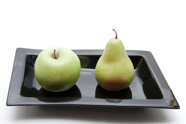 Apple and pear in ceramic scarfs — Stock Photo, Image