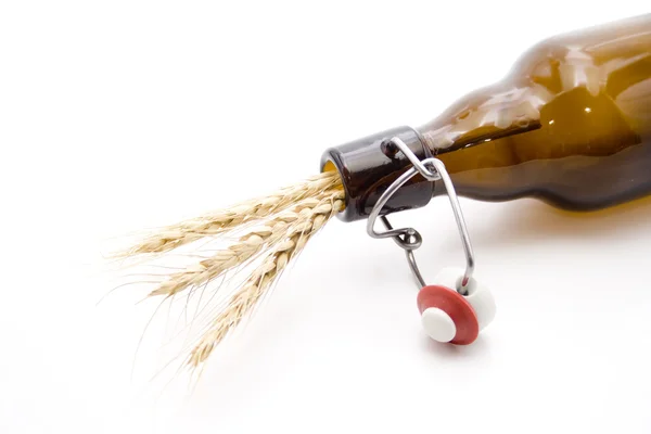 Brown glass bottle with wheat ear — Stock Photo, Image