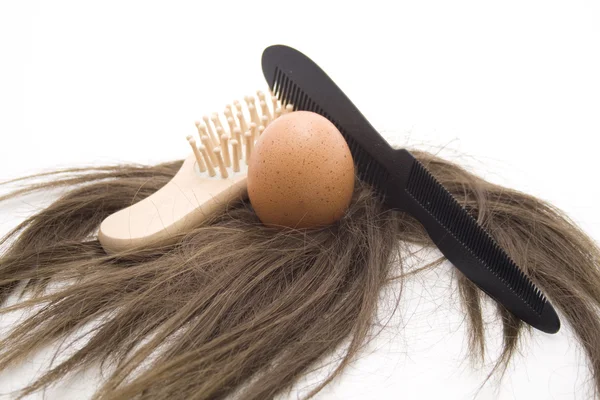 Hairbrush with hairpiece Royalty Free Stock Images
