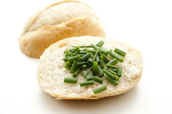 Fresh chives and bread roll — Stock Photo, Image