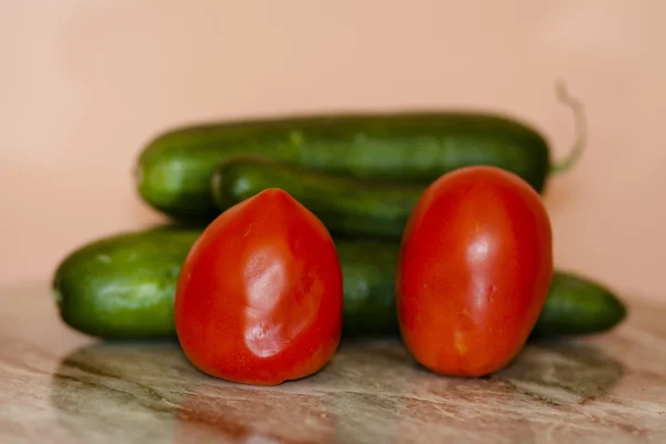 Tomatoes with cucumbers — Stock Photo, Image