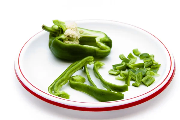 Green paprika in pieces and stripes on plate — Stock Photo, Image