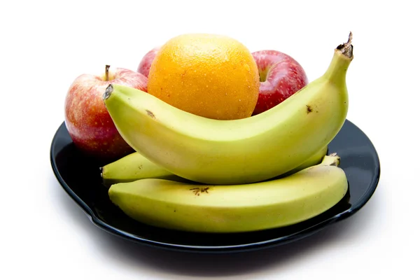 Червоне яблуко з бананом на тарілці Стокове Фото