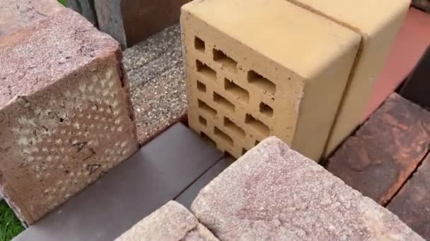4k video review of different bricks lying on the grass — ストック動画