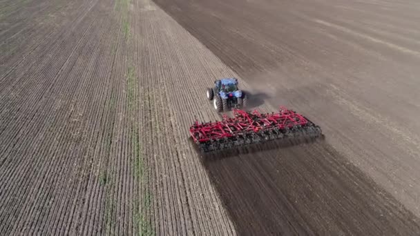 Ciągnik rolniczy na polu puch ziemi. Obraz z lotu ptaka 4k — Wideo stockowe