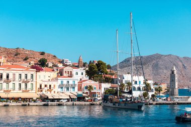 Yunanistan 'ın Symi adasındaki eski liman limanının kıyısındaki saat kulesi deniz feneri.