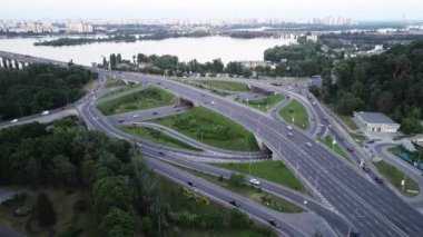 Akşam Kyiv 'deki Paton Köprüsü' nde trafik ışıkları ve arabalar Ukrayna 'nın yol kavşağı boyunca ilerliyor. Hava görüntüsü. video görüntüleri 4k kalite