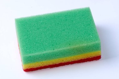 Tri-coloured household cleaning sponge on white background