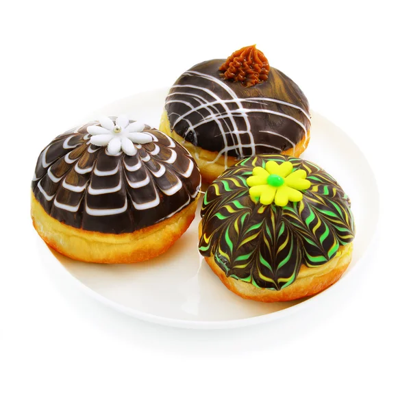 Três donuts com chocolate — Fotografia de Stock
