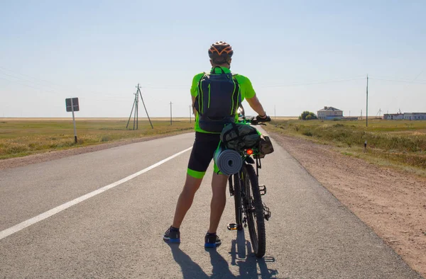 bicycle tourist riding in the village, Kazakhstan