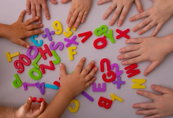 Preschoolers learning letters, english alphabet. top view