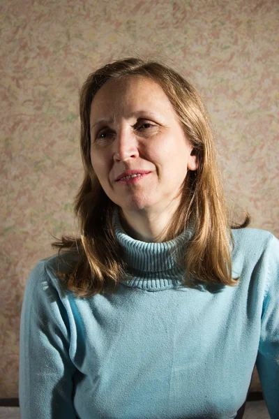 A woman in a blue sweater — Stock Photo, Image