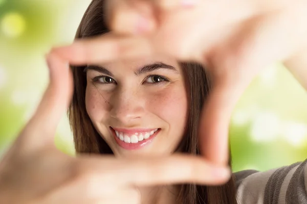 Young beautiful woman making frame with her hands — Stock Photo, Image