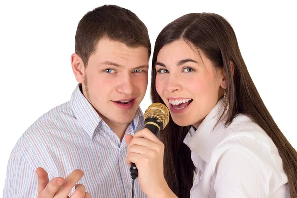 Friends singing in microphone at karaoke party and having fun — Stock Photo, Image