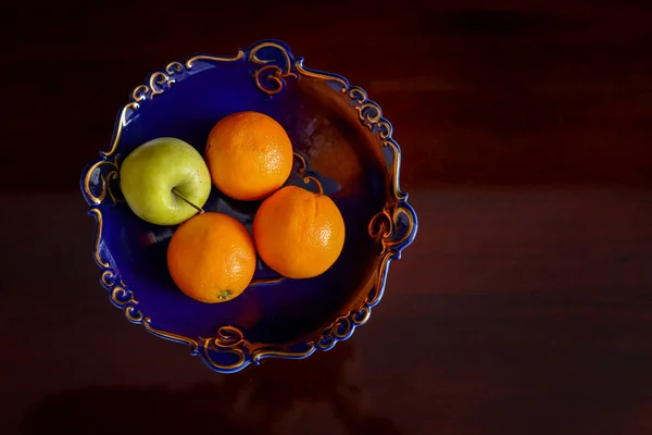 Oranges and apple — Stock Photo, Image