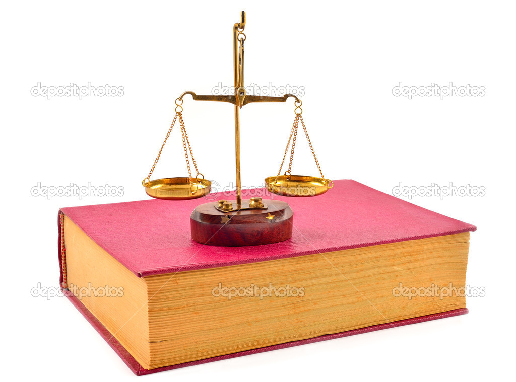 book and scales of justice over white background