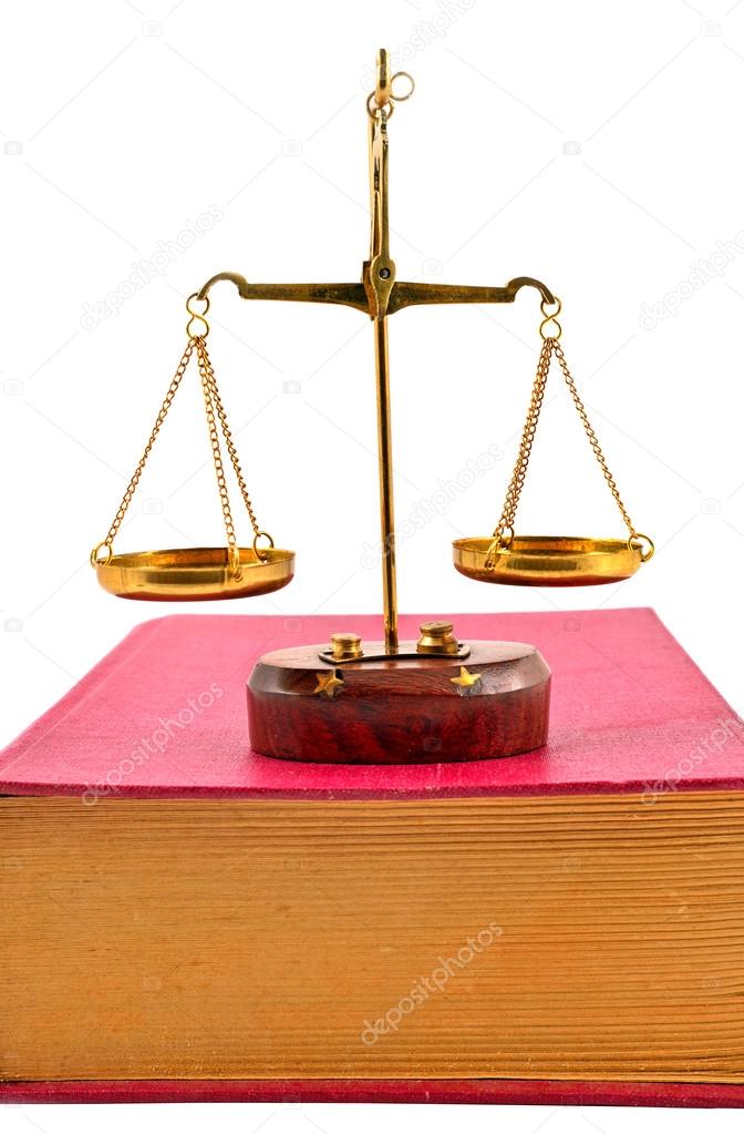 Scales of justice atop books