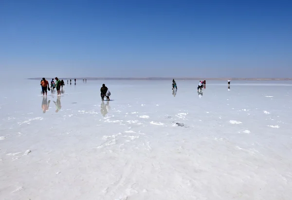 people walking on the frozen salt, in Turkey