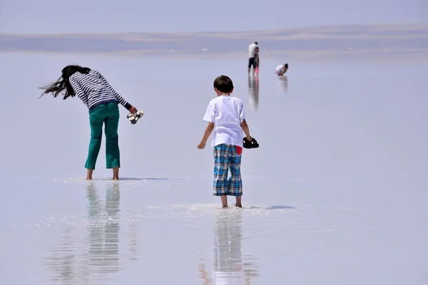 people walking on the frozen salt, in Turkey
