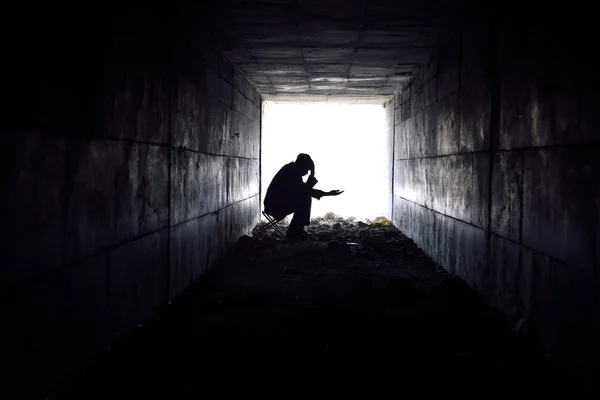 Sad man sitting in the tunnel — Stock Photo, Image