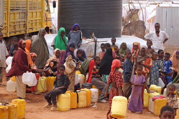 people waiting to fill water and mess