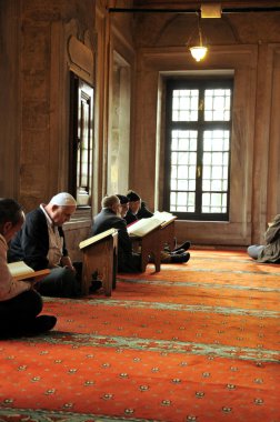 Muslim men reading the Holy Quran clipart
