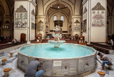 BURSA, TURKEY - AUGUST 21: An interior view of Grand Mosque (Ulu Cami) on August 21, 2022 in Bursa, Turkey. The very aesthetic fountain of the Great Mosque of Bursa, which receives light from its dome.