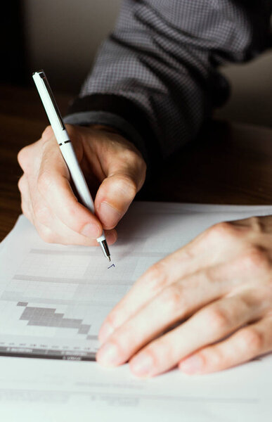 close up of businessman signing contract with a pen, closeup