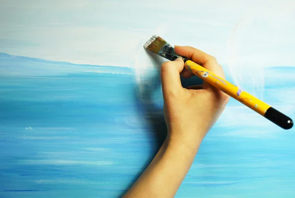 Artist hand with paintbrush painting the picture — Stock Photo, Image