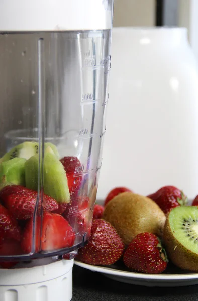 Fresh fruits in the blender — Stock Photo, Image