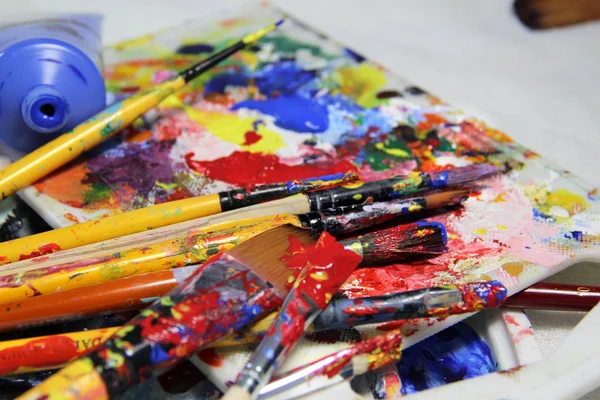 Art palette, tubes with paints and paintbrushes — Stock Photo, Image