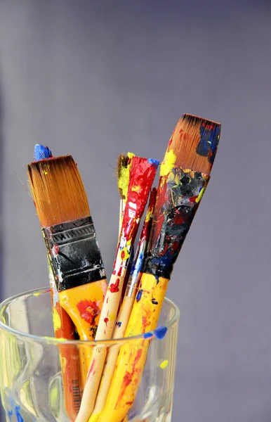 Mix of paintbrushes stained with paints — Stock Photo, Image