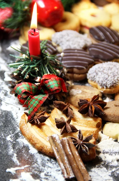 Mix of Christmas cookies with cinnamon and candle — Stock Photo, Image