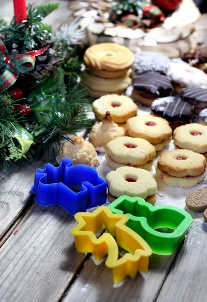 Mix of Christmas cookies with cinnamon and candle — Stock Photo, Image