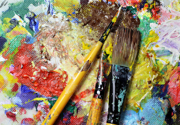 Beautiful vivid art palette and mix of paintbrushes