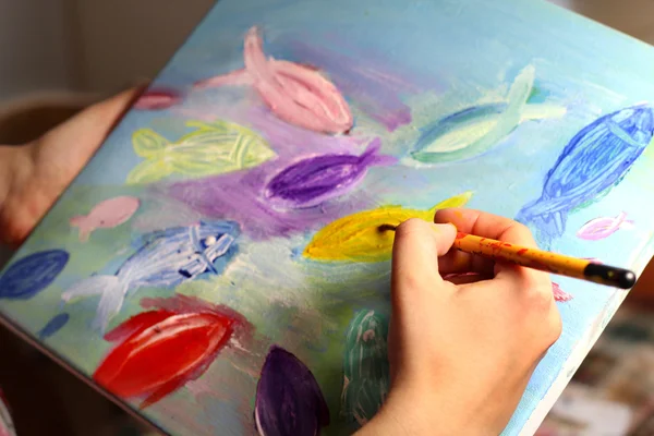 Artists hand with paintbrush painting the picture — Stock Photo, Image