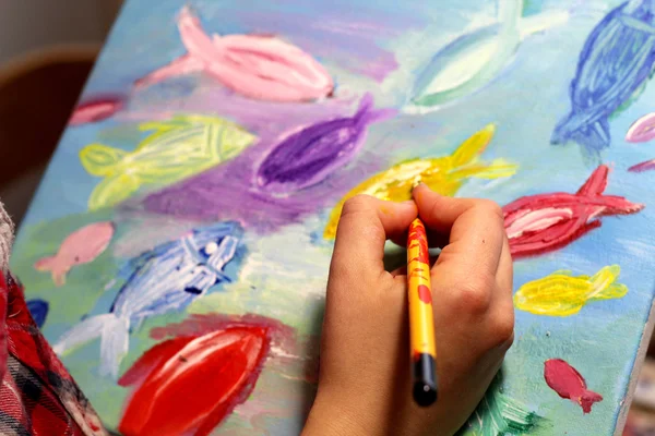 Artists hand with paintbrush painting the picture — Stock Photo, Image