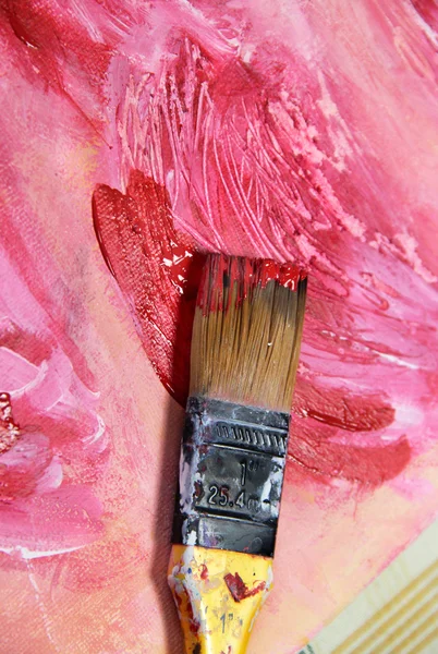 Paintbrush and beautiful painting with flowers — Stock Photo, Image