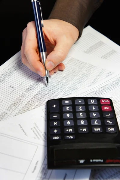 Office table with calculator, pen and accounting document — Stock Photo, Image