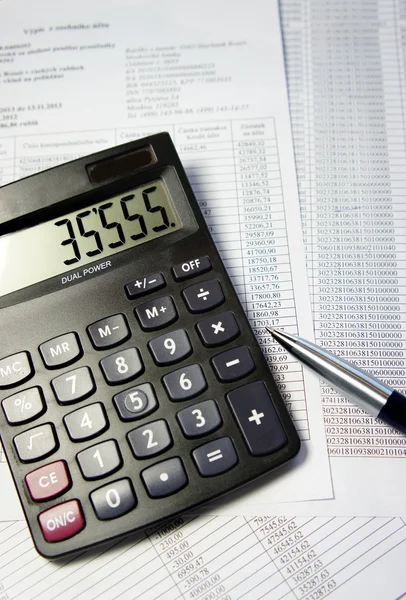 Office table with calculator, pen and accounting document — Stock Photo, Image