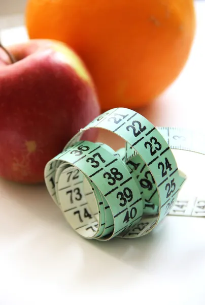 Fruits and measurement tape on the white background — Stock Photo, Image