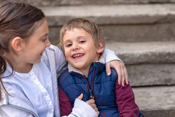 Two Kids Sitting Stairs Siblings Love Older Sister Hugging Her — Fotografia de Stock