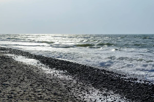 Sandy Sea Coastline Pebbles Sunlight — стоковое фото
