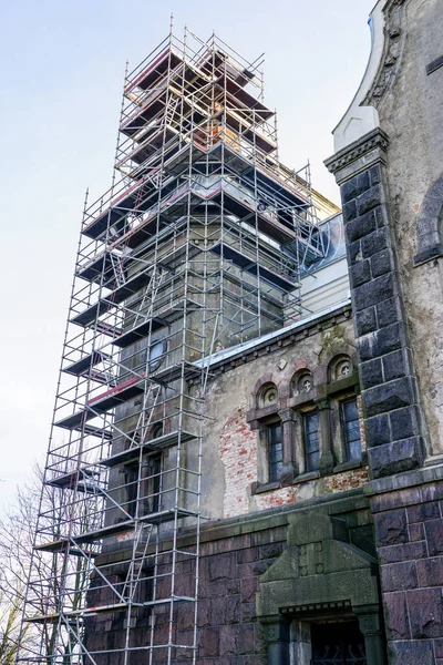 scaffolding of complicated configuration for the restoration and replacement of the roof of a historic church tower