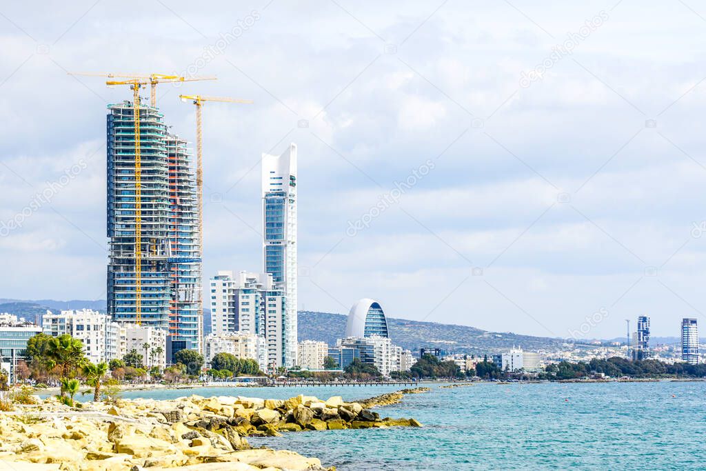 view of the Limassol promenade with several tower cranes and skyscrapers under construction