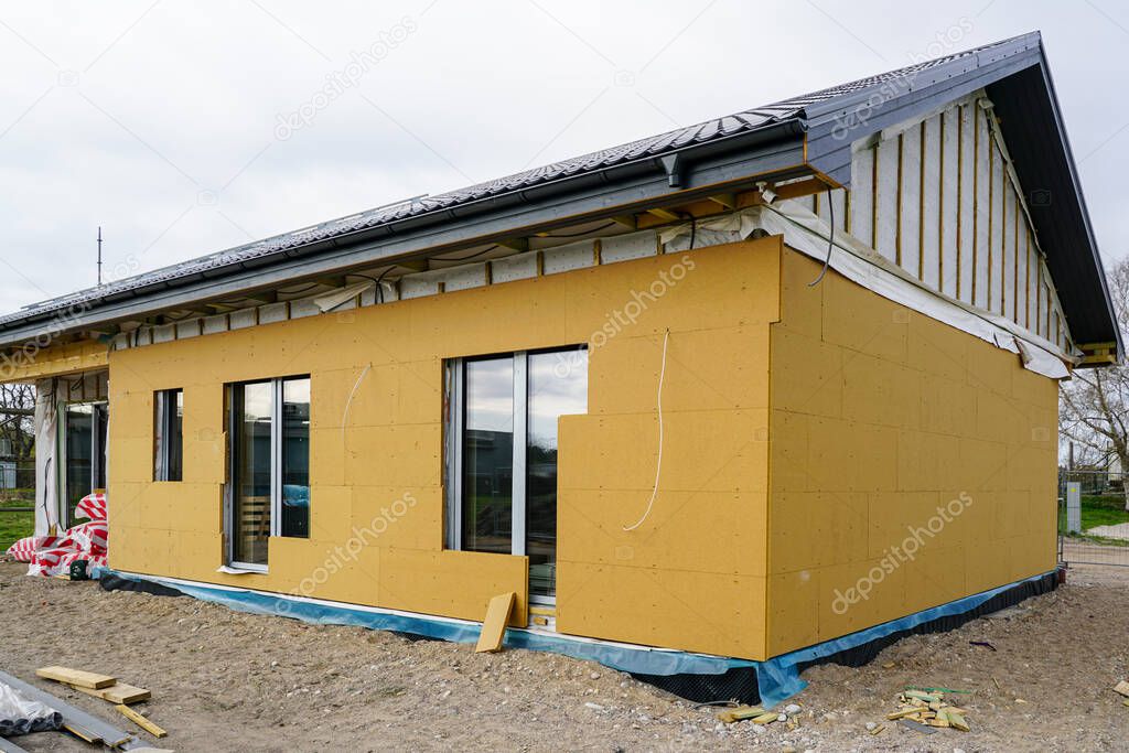 Unfinished modern prefabricated single storey private house with gray metal roof