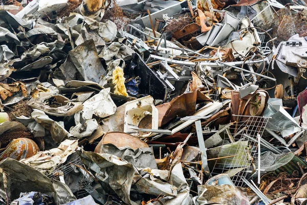 Different household and industrial scrap metal pile background